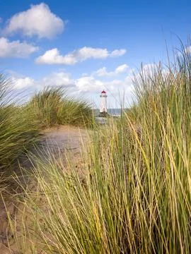 White Puffy Clouds and The Point of Ayr Lighthouse Stock Photos