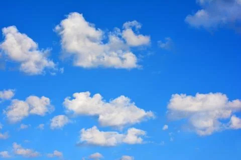 White Puffy Clouds on a Beautiful Blue Sky Stock Photos