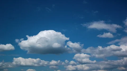 White Puffy Clouds Drifting Across Blue Sky in Time Lapse Stock Footage 94499307