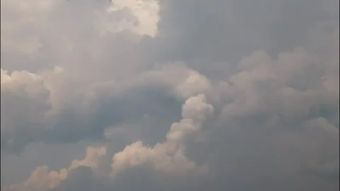 White puffy clouds drifting across a bright blue sky during a sunny afternoon Stock Footage 340902300