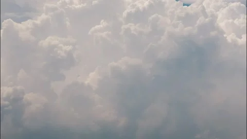 White puffy clouds drifting across a bright blue sky during a sunny afternoon Stock Footage 340902314