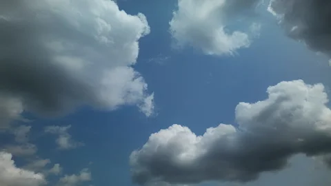 White Puffy Clouds Floating in the Blue Sky Timelapse Stock Footage 311642005