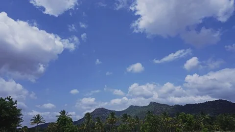 White Puffy Clouds Passing Over A Tropical Landscape TimeLapse Видео 78181317