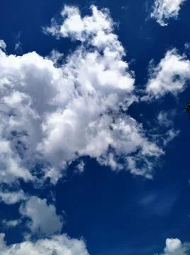 White puffy clouds Stock Photos