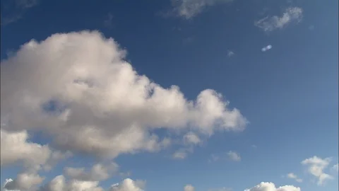 White puffy clouds rolling over the blue sky, Rich blue sky and fluffy white Stock Footage 109153118