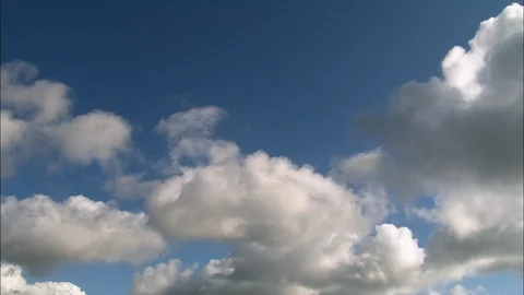 White puffy clouds rolling over the blue sky, Rich blue sky and fluffy white Vidéo 109153358