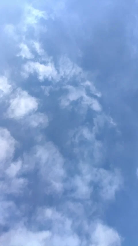 White puffy clouds timelapse across blue sky. Stock Footage 329164156