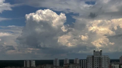 White puffy fluffy clouds time-lapse with blue sky background over city district Stock Footage 150907297