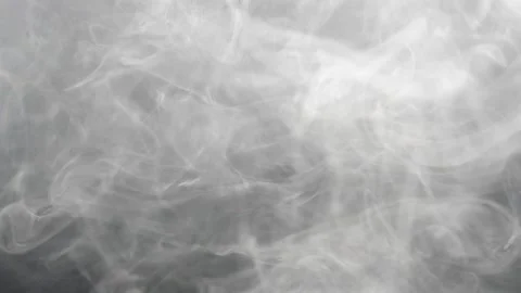 White puffy smoke isolated against black background swirling Stock Footage 202732076