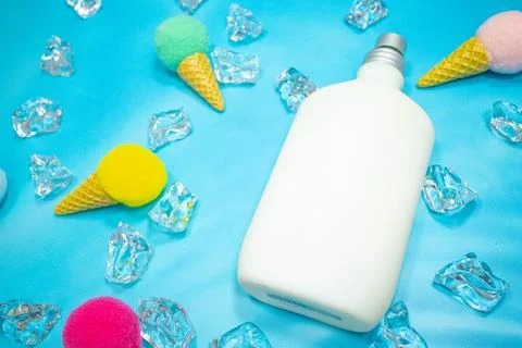 White pump perfume container on blue background Stock Photos