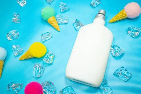 White pump perfume container on blue background Stock Photos