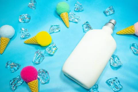 White pump perfume container on blue background Stock Photos