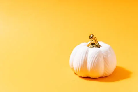 White pumpkin on orange background with copy space, Minimal Halloween concept Stock Photos