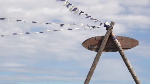 White - purple fluttering in the wind. Blue sky with clouds. Hanging garlands Stock Footage 256094499