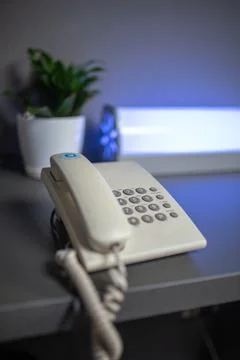 White push-button office phone on the table Stock Photos