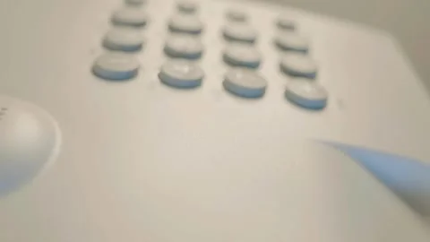 White push-button old telephone with the receiver removed and lying nearby Stock Footage 287937765