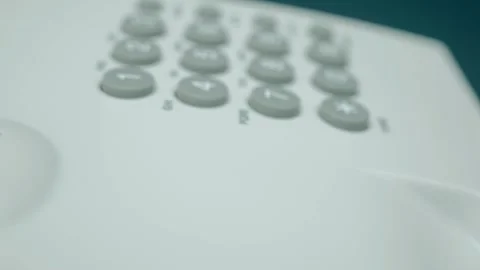 White push-button old telephone with the receiver removed and lying nearby Stock Footage 287949139