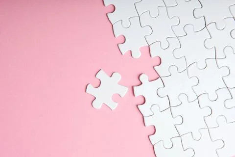 White puzzle on a colored background top view. Stock Photos