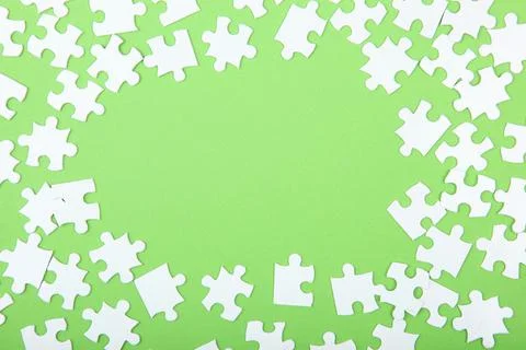 White puzzle on a colored background top view. Stock Photos