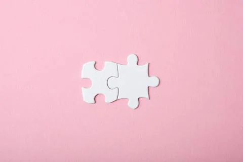 White puzzle on a colored background top view. Stock Photos