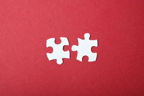 White puzzle on a colored background top view. Stock Photos