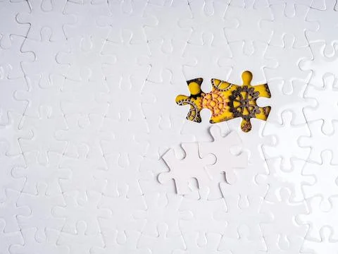 White puzzle with missing piece revealing mechanical gears underneath on ye.. Stock Photos