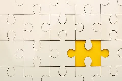 White puzzle with missing piece on yellow background, top view Foto stock