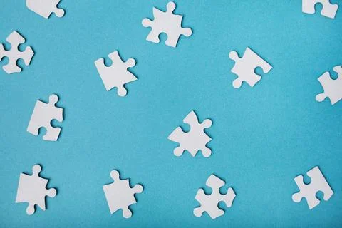 .White puzzle pieces on a blue background. Rest from gadgets. Stock Photos