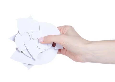 White puzzles pieces in hand Stock Photos