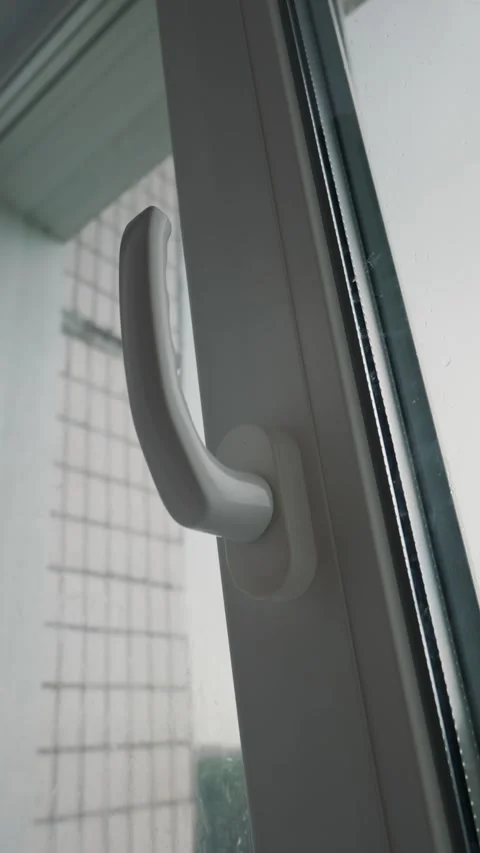White Pvc Window Handle Turned Upwards Against Blurred City Building Stock Footage 339186947
