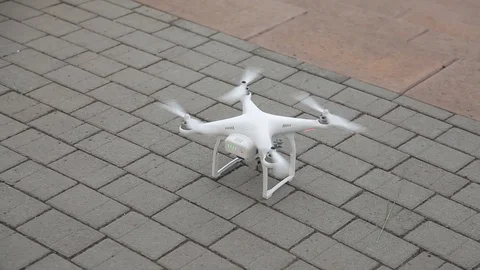White quadcopter ready to fly Stock Footage 76967232