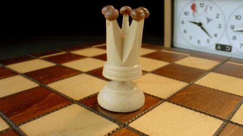 White queen on rotating chess board, macro Video stock 112049783