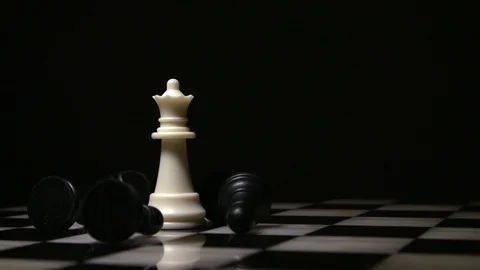 White queen surrounded by fallen black pawns Stock Footage 92525655