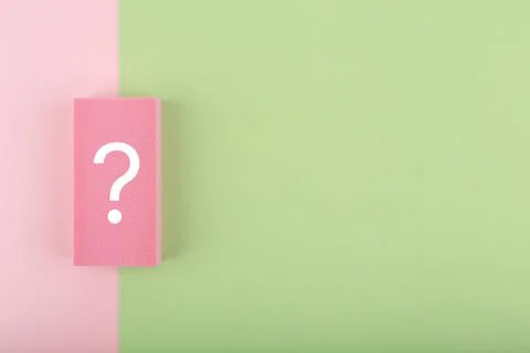White question mark on colored pink and green background with copy space Stock Photos