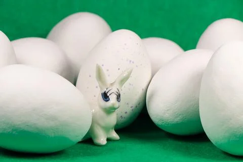 White Rabbit With Large Chocolate Candy Easter Eggs On Green Stock Photos