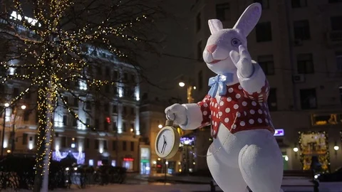 White Rabbit with pocket clock on the decorated street in the city Stock Footage 70334700