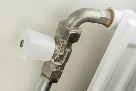 White radiator button on a heating element. Stock Photos