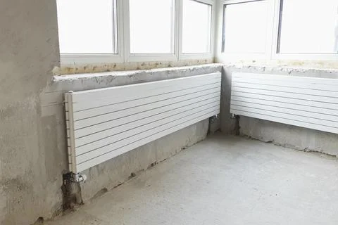 White radiators of heating system. New building house, heating i Fotos de archivo