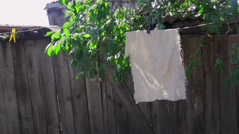 White rag in the wind outside drying on a clothesline, copy space 動画素材 136268408