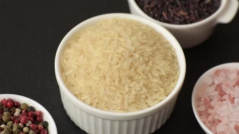 White raw rice in a ceramic bowl. Rice as an ingredient Stock Footage 305492238