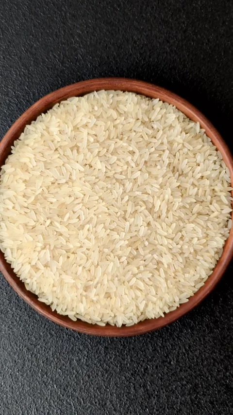 White raw rice in a ceramic bowl. Rice as an ingredient Stock Footage 305492338