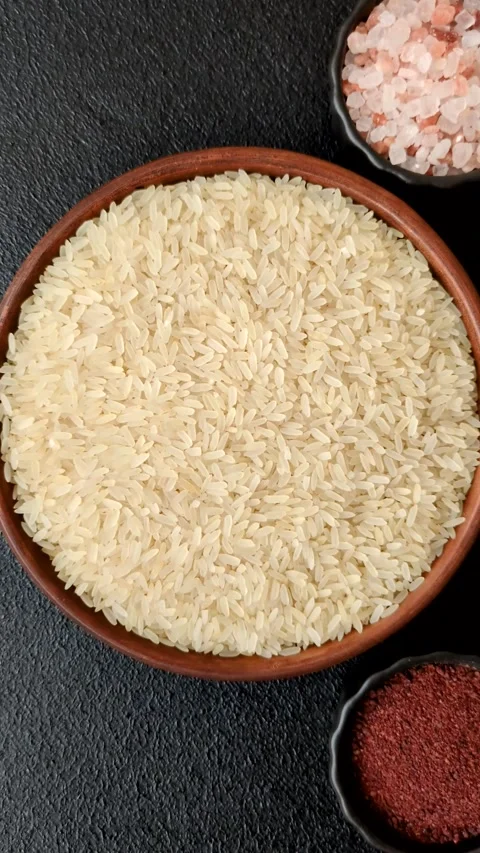 White raw rice in a ceramic bowl. Rice as an ingredient Stock Footage 305492345
