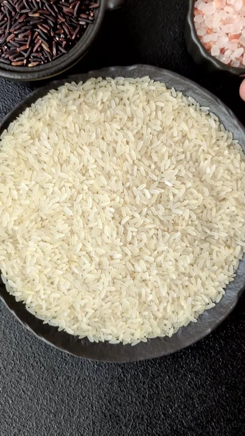 White raw rice in a ceramic bowl. Rice as an ingredient Stock Footage 305492352