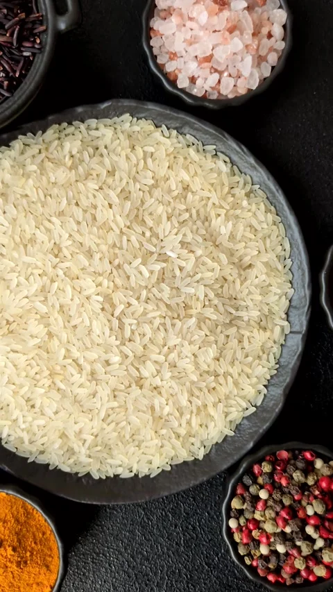 White raw rice in a ceramic bowl. Rice as an ingredient Stock Footage 305492357