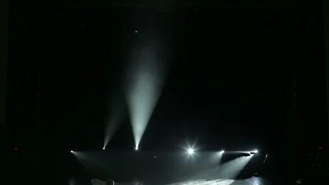 The white rays alternately flash on stage in the dark. Empty concert stage. Stock Footage 100361376