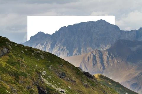 White rectangle in the middle of cloudy mountain landscape. Natural and unkown. Illustrazione stock