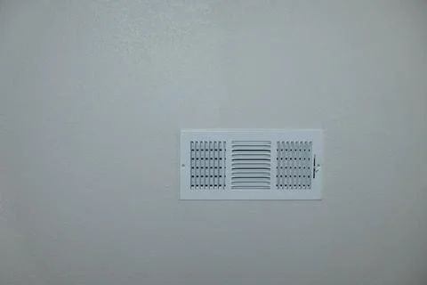 White rectangular air vent mounted on textured wall, HVAC ventilation grille Fotos Stock