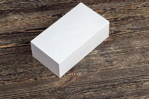 A white rectangular box on a black board Stock Photos