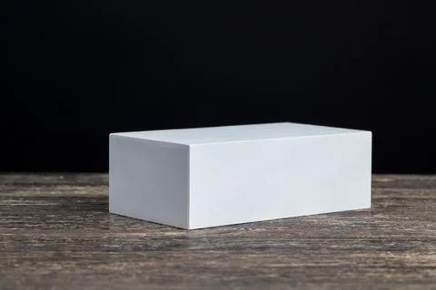 A white rectangular box on a black board Stock Photos