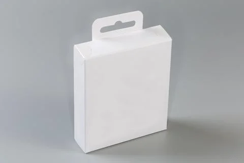 White rectangular cardboard hang tab packing box on gray surface Stock Photos